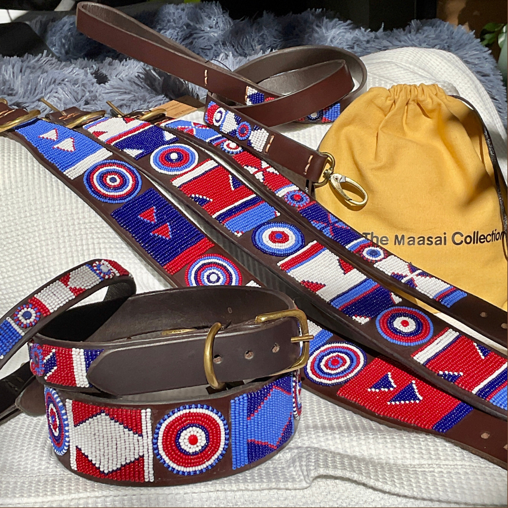 group photo of multiple different sizes and widths of red white and blue handmade beaded leather collars and leashes from The Maasai Collection in Liberty design