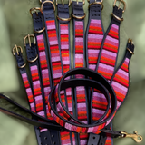 group photo of multiple different sizes and widths of pink and gold handmade beaded leather collars from The Maasai Collection in Flamingo design on black leather