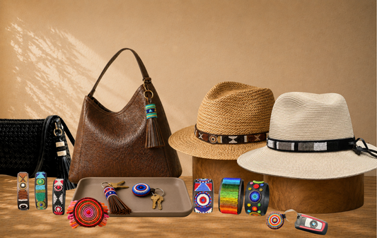 A range shot of beaded leather accessories from The Maasai Collection including hat bands, keychains, bag charms and  variety of sizes of beaded leather bracelets